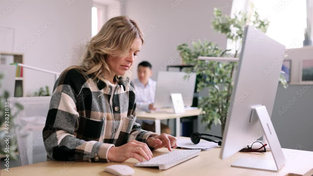 Portrait of beautiful adult businesswoman while he working in the office. Attractive office worker looking at the camera. High quality 4k footage Portrait of beautiful adult businesswoman while he working in the office. Attractive office worker looking at the camera. High quality 4k footage