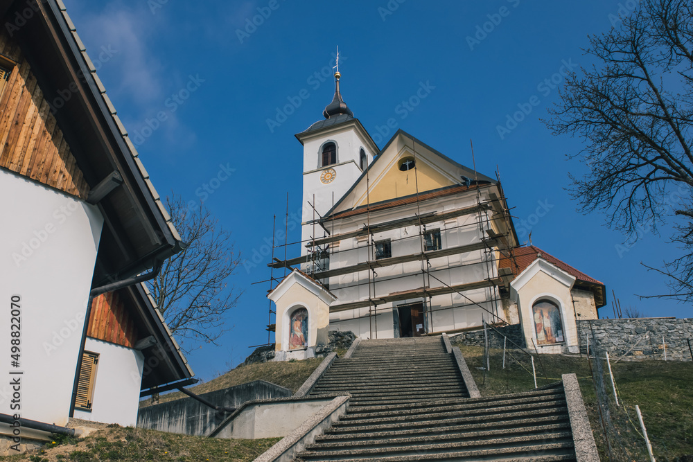 Frog view of Saint Mohor and Fortunat church on the top of the hill in central Slovenia close to Lukovica.