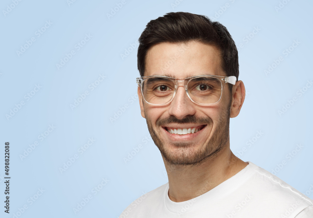 Young casual attractive European man smiles friendly while looking at camera Young casual attractive European man smiles friendly while looking at camera
