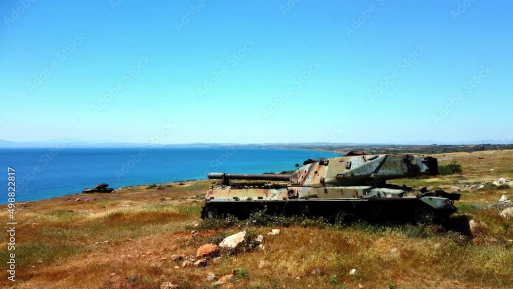 Drone flight over broken and abandoned old tanks on the picturesque Mediterranean coast in Cyprus in the spring on a sunny day. Drone flight over broken and abandoned old tanks on the picturesque Mediterranean coast in Cyprus in the spring on a sunny day.