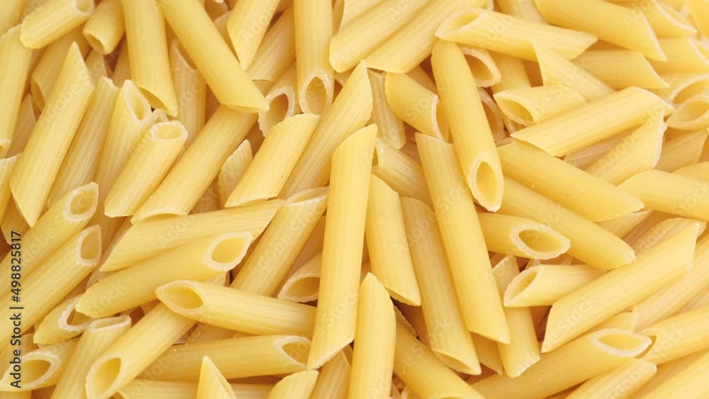 Dry uncooked Italian macaroni rotating close up. High quality 4K footage Dry uncooked Italian macaroni rotating close up. High quality 4K footage