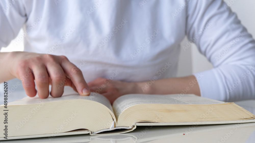 Woman reading the bible, pointing finger on text Woman reading the bible, pointing finger on text