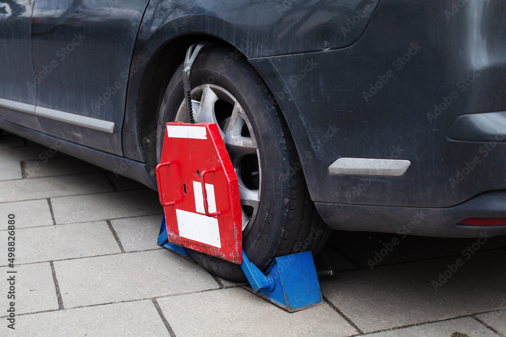 Car wheel clamp Locked illegally parked cars Car wheel blocked by wheel