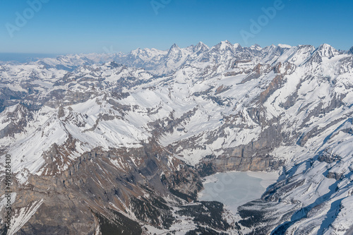 aerial view of Lake Oeschinensee in spring with Eiger, Mönch and Jungfrau