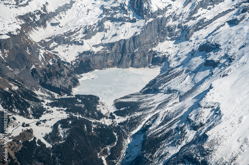 aerial view of still frozen Lake Oeschinensee in spring