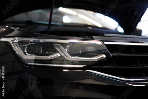 Close-up showing the front of a modern clean car. Selected focus. © Орлов Александр