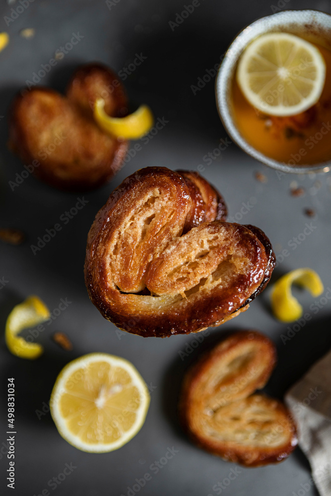 Lemon Palmiers, made from puff pastry on a dark background Lemon Palmiers, made from puff pastry on a dark background