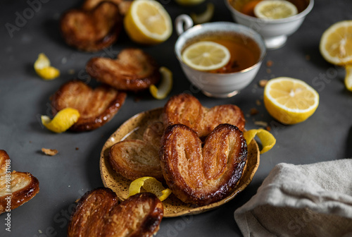 Lemon Palmiers, made from puff pastry on a dark background photo