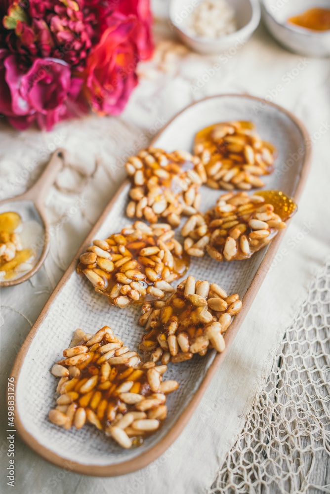 Pine Nut Caramel biscuits on a white ceramic plate Pine Nut Caramel biscuits on a white ceramic plate