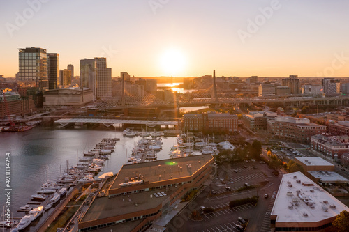 Aerial view of downtown Boston from Boston Harbor during sunset with sun rays