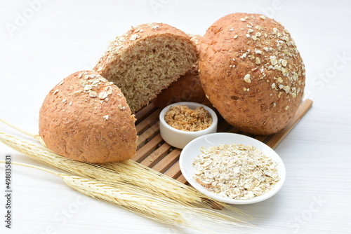 Round wholemeal oat bread, sweetened with natural panela, displayed on white wood