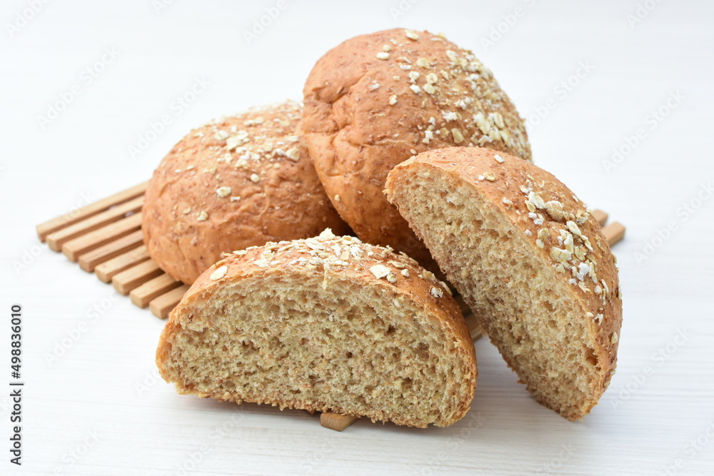 Round wholemeal oat bread, sweetened with natural panela, displayed on white wood