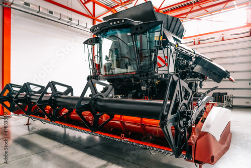 New modern industrial agriculture combine harvester in large garage.
