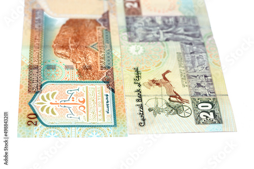 Reverse sides of Saudi Arabia 20 twenty riyals banknote with 20 LE twenty Egyptian pounds bill isolated on a white background, Selective focus of Egyptian and Saudi money exchange rate photo
