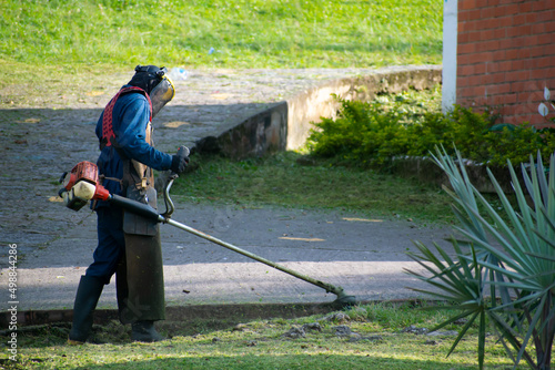 man mowing the lawn of a school field 