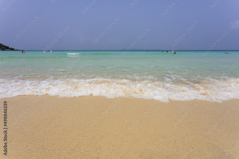 wave on the white sand beach and space on blue sky on sunny day