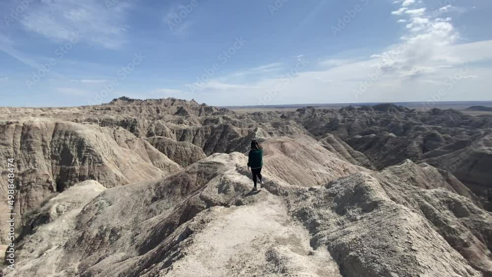 Woman hiking at Badlands National park, South Dakota Woman hiking at Badlands National park, South Dakota