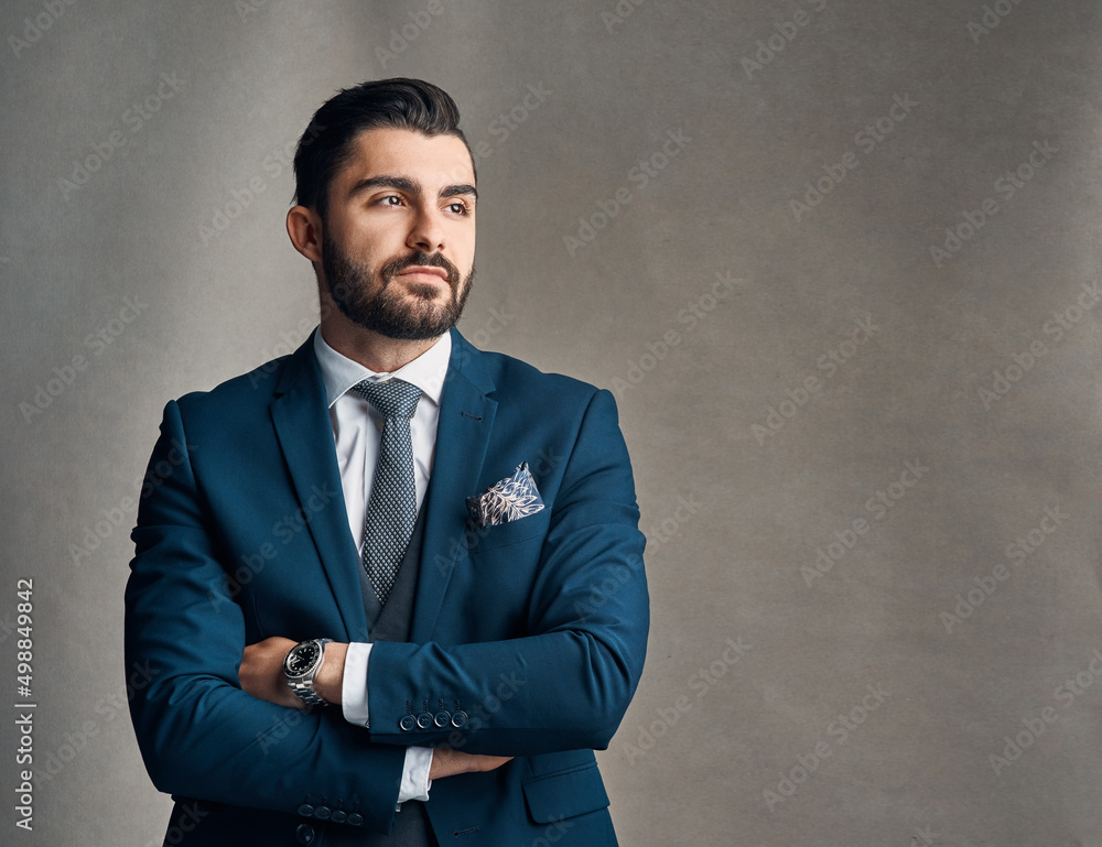 Determination defines success. Studio shot of a stylishly dressed young businessman envisioning success against a grey background. Determination defines success. Studio shot of a stylishly dressed young businessman envisioning success against a grey background.