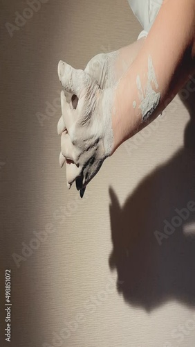 romantic movements of hands, a couple in love. smooth movements of male and female hands close-up, in a pottery workshop, all in clay. vertical video photo