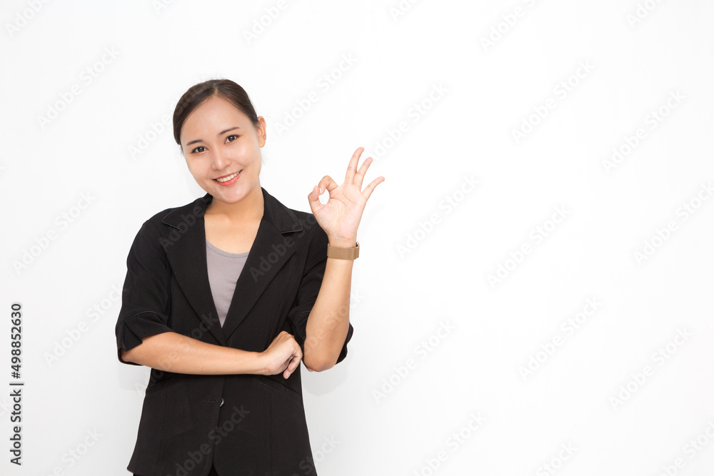 Beautiful Asian business woman wearing black suit okay sing presenting something on white background and copy space. Confident Asian working woman smiling and cheerful Beautiful Asian business woman wearing black suit okay sing presenting something on white background and copy space. Confident Asian working woman smiling and cheerful
