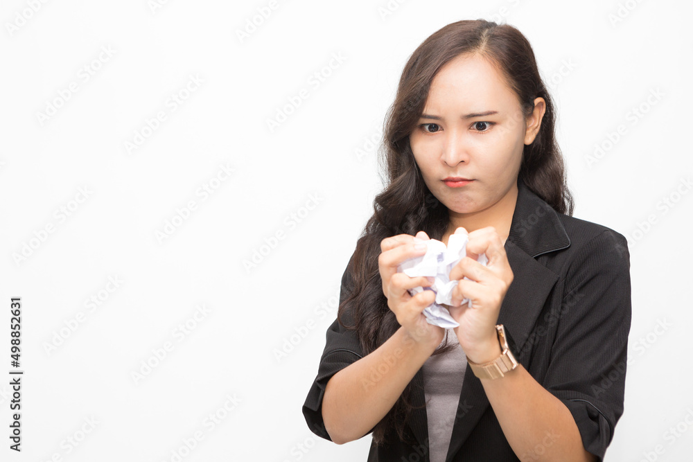 Beautiful Asian business woman wearing black suit. Angry woman crumples documents and stress on white background and copy space Beautiful Asian business woman wearing black suit. Angry woman crumples documents and stress on white background and copy space