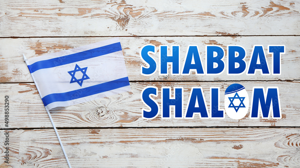 Flag of Israel and text SHABBAT SHALOM on wooden background Stock Photo