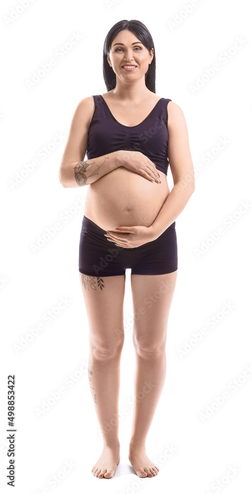 Fototapeta premium Pregnant young woman isolated on white