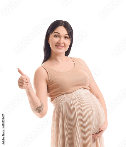 Pregnant young woman showin...