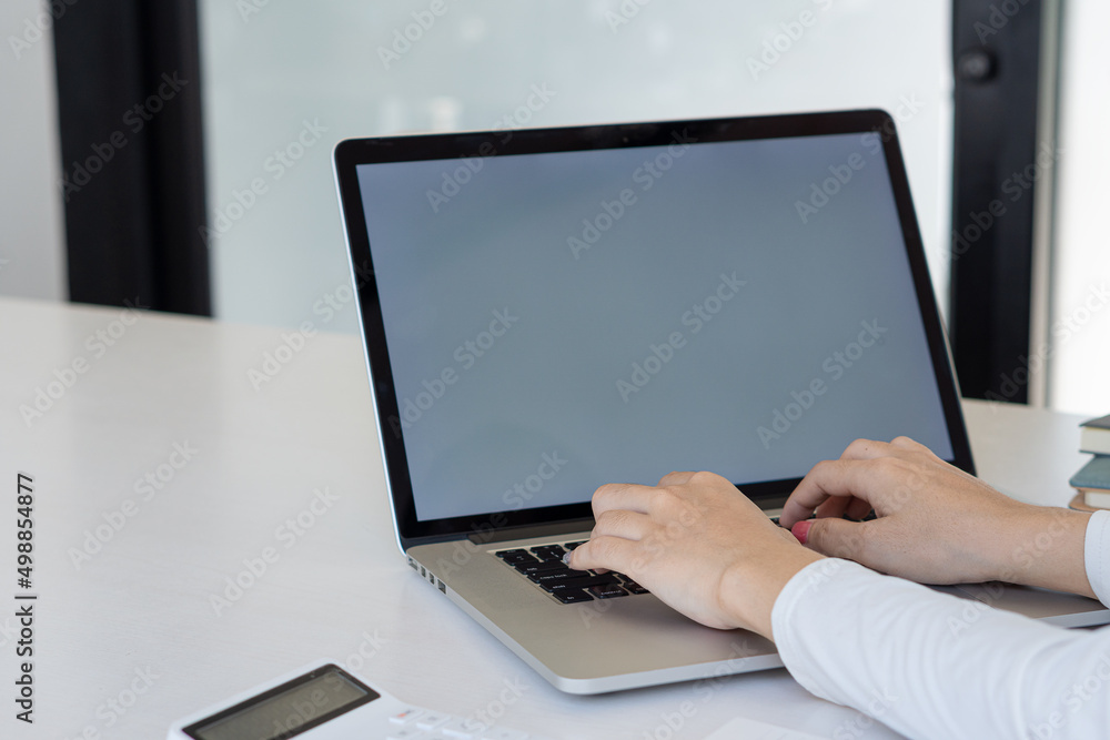 Close-up of hands typing on laptop computer keyboard and surfing the internet on the desk. Online, business, and technology. communication concept Close-up of hands typing on laptop computer keyboard and surfing the internet on the desk. Online, business, and technology. communication concept
