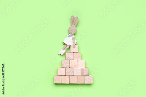 Wooden cubes with toy on gr...