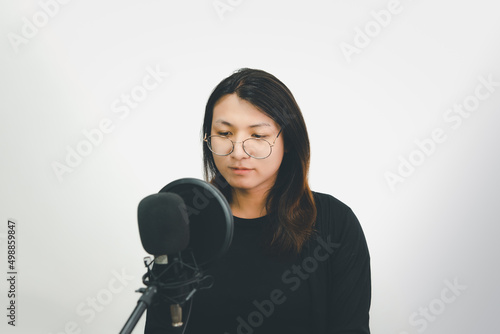 Woman (LGBTQ) singer sing a song with microphone photo