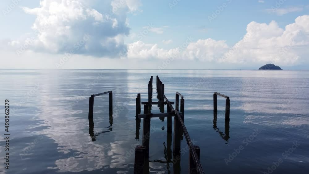 Silhouette wooden abandoned pier in blue sunny sky day Silhouette wooden abandoned pier in blue sunny sky day