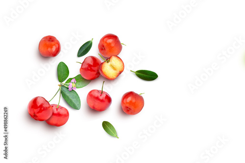 Acerola cherry with half slice and green leaves isolated on white background, top view, flat lay. photo