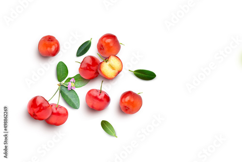 Photos Acerola cherry with half slice and green leaves isolated on white background, top view, flat lay