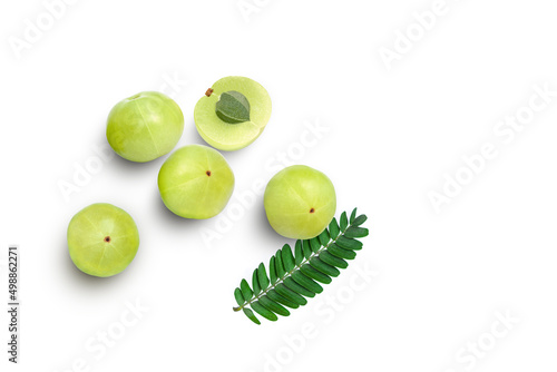 Indian gooseberry fruits (Amla, phyllanthus emblica) with green leaves isolated on white background. Top view. Flat lay.