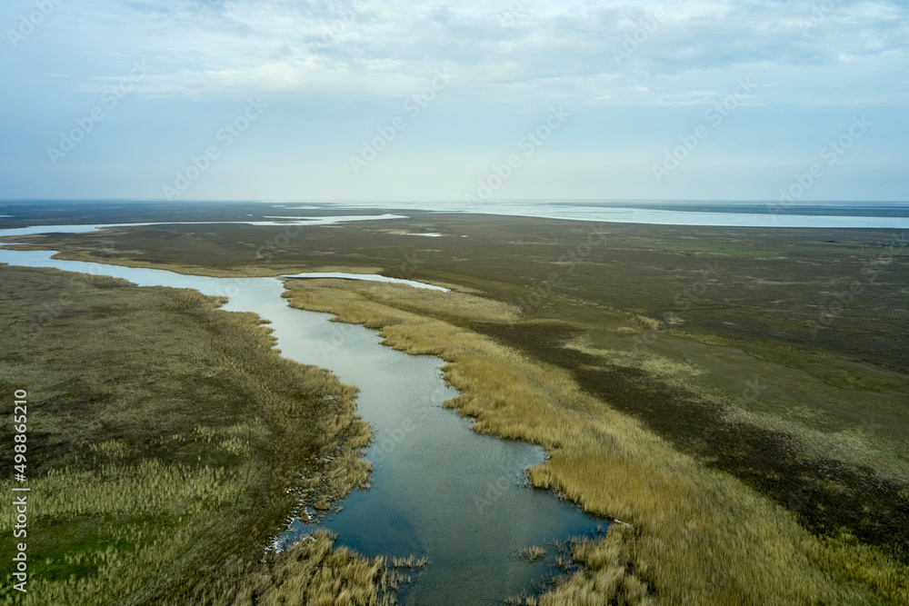 steppe plain landscape lake in the middle of fields