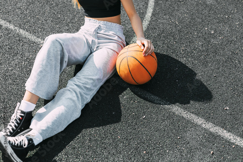 Close-up of a girl with a basketball on a sports field or a school stadium