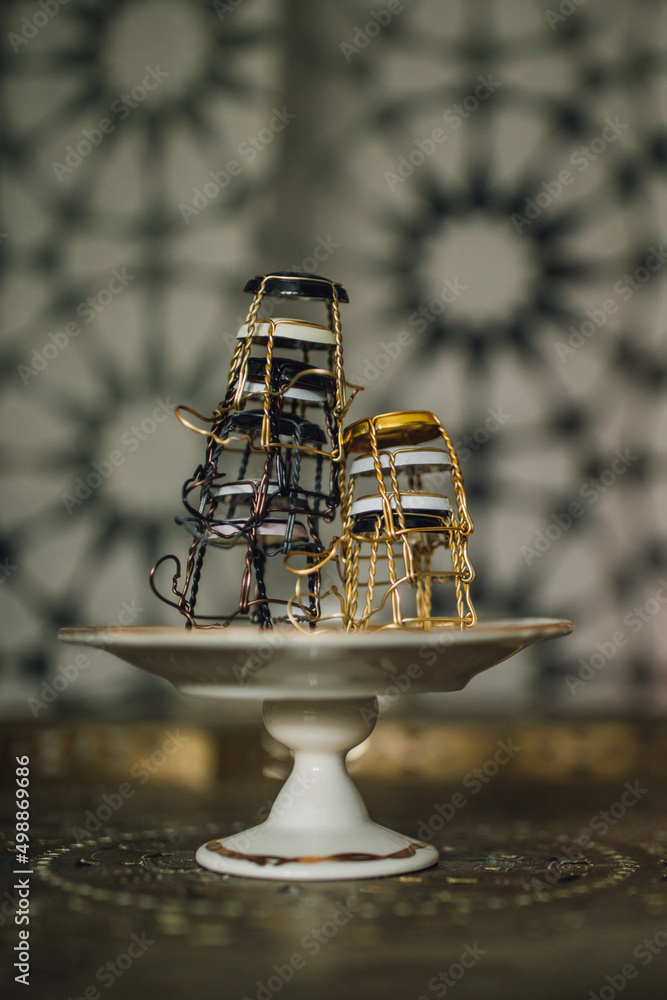 stack of Champagne cages on tiny pedestal dish stack of Champagne cages on tiny pedestal dish