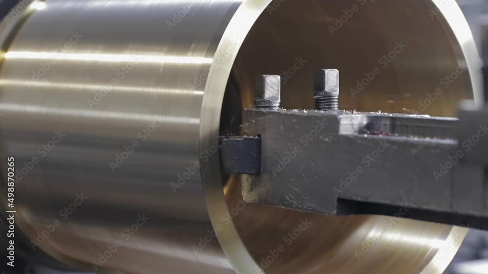 The rotating part on the lathe is processed with a special cutter. Flying chips. Close-up. Soft focus The rotating part on the lathe is processed with a special cutter. Flying chips. Close-up. Soft focus
