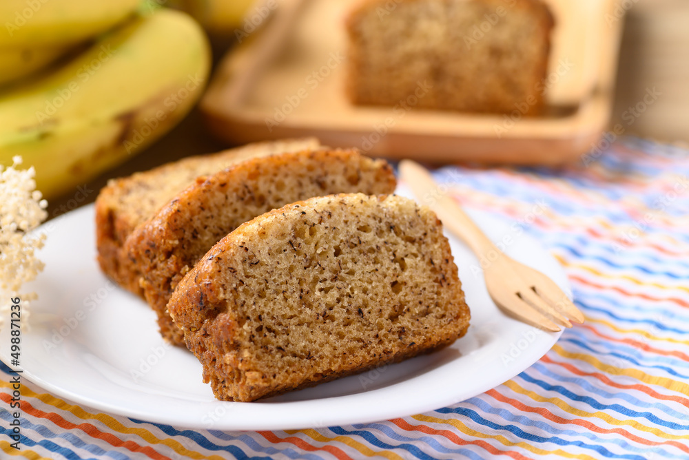 Banana bread on white plate with fork ready to eating Banana bread on white plate with fork ready to eating