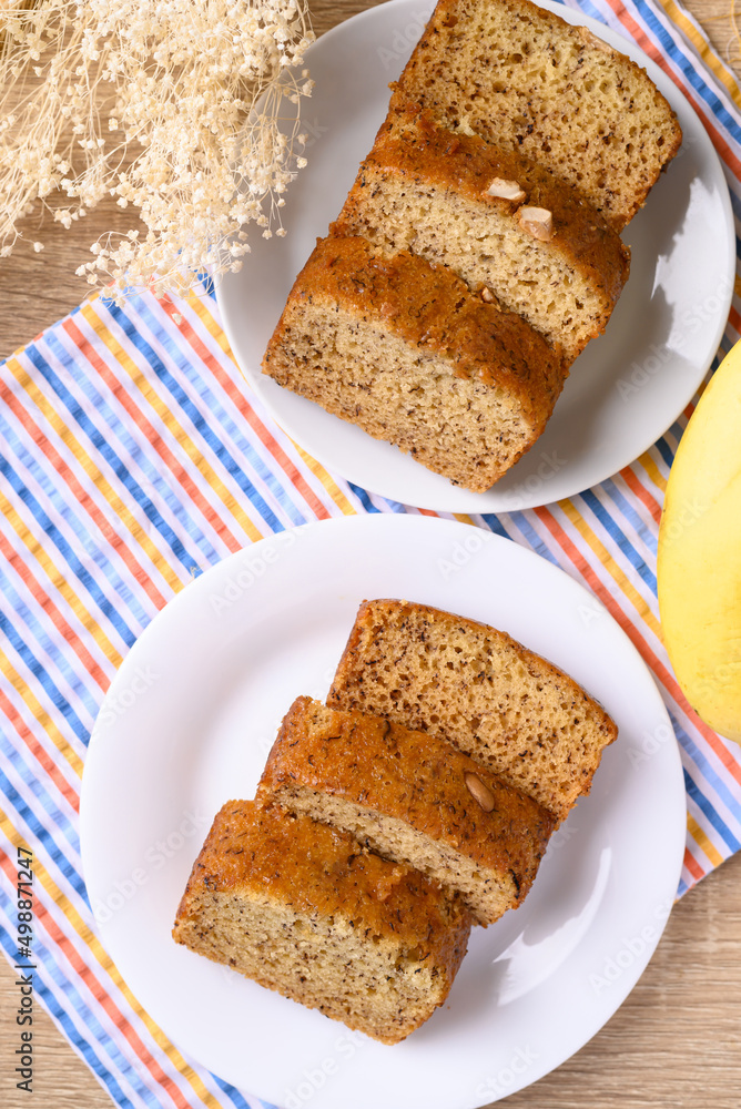 Banana bread on white plate, Table top view Banana bread on white plate, Table top view