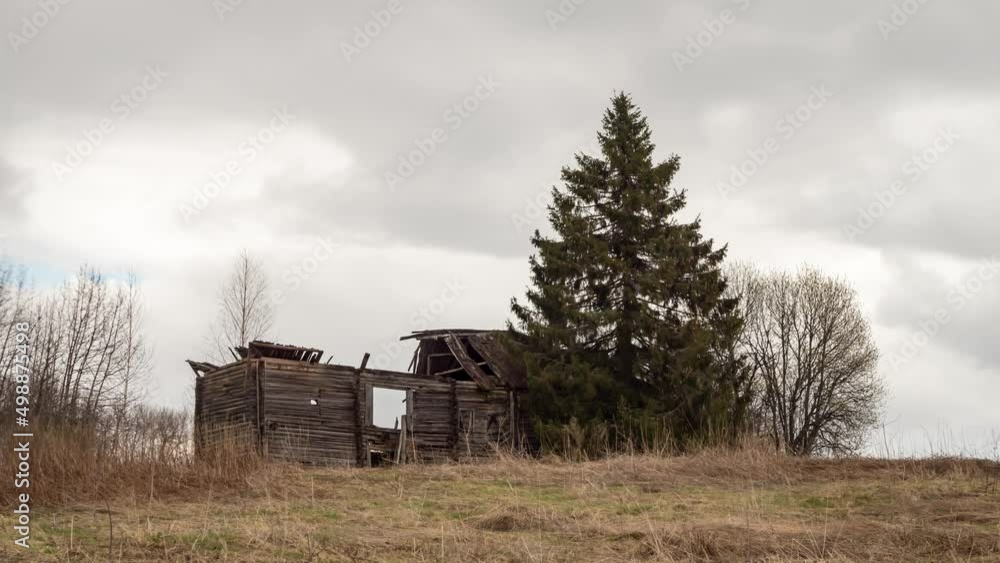 View of ruins of abandoned rural house and tree in front of cloudy sky. Time-lapse. View of ruins of abandoned rural house and tree in front of cloudy sky. Time-lapse.