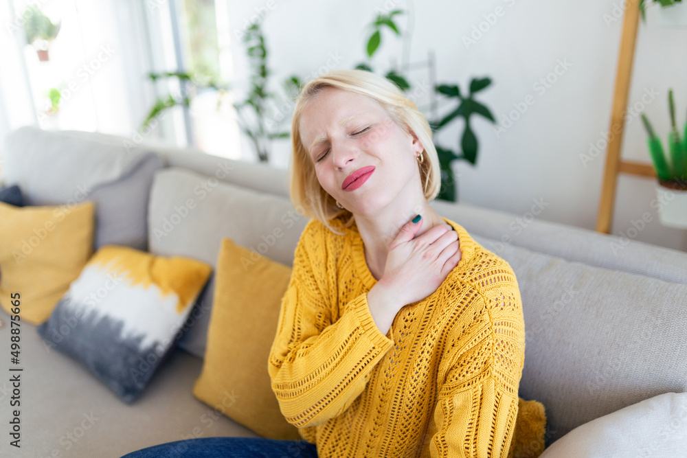 Pain in the shoulder. Upper arm pain, People with body-muscles problem, Healthcare And Medicine concept. Attractive woman sitting on the bed and holding painful shoulder with another hand. Pain in the shoulder. Upper arm pain, People with body-muscles problem, Healthcare And Medicine concept. Attractive woman sitting on the bed and holding painful shoulder with another hand.