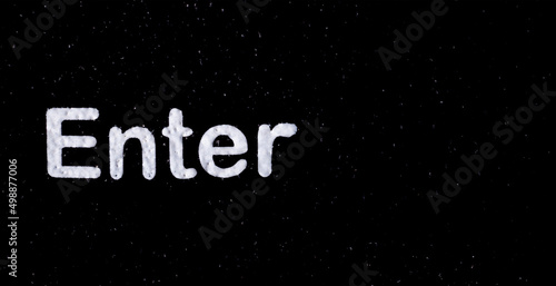 White "Enter" letter on black background