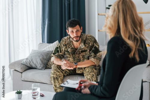 Soldier have therapy session with psychologist indoors photo