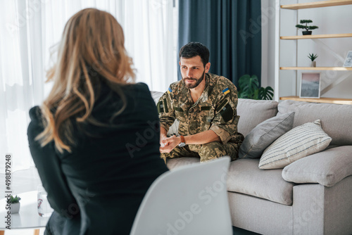 Soldier have therapy session with psychologist indoors