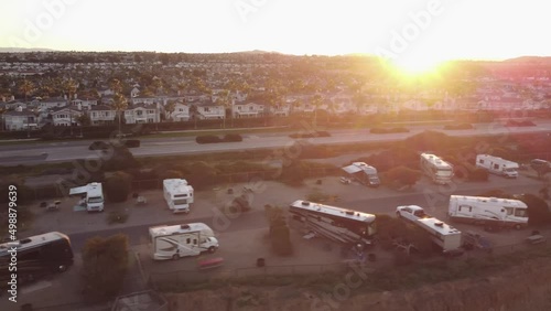 A beautiful aerial drone shot, flying above a bus park revealing the town of Carlsbad, Carlsbad State Beach - California photo