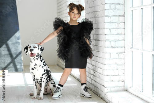 Fashion children. Little girl with a dog posing in fashionable clothes. High quality photo photo