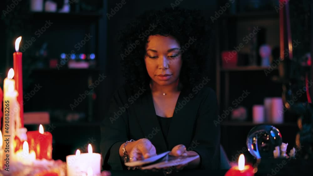 Mysterious psychic shuffling and holding out tarot cards, witchcraft business Mysterious psychic shuffling and holding out tarot cards, witchcraft business