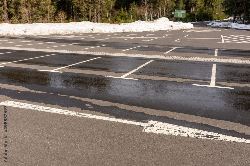 Empty parking lot in winter at the edge of the forest